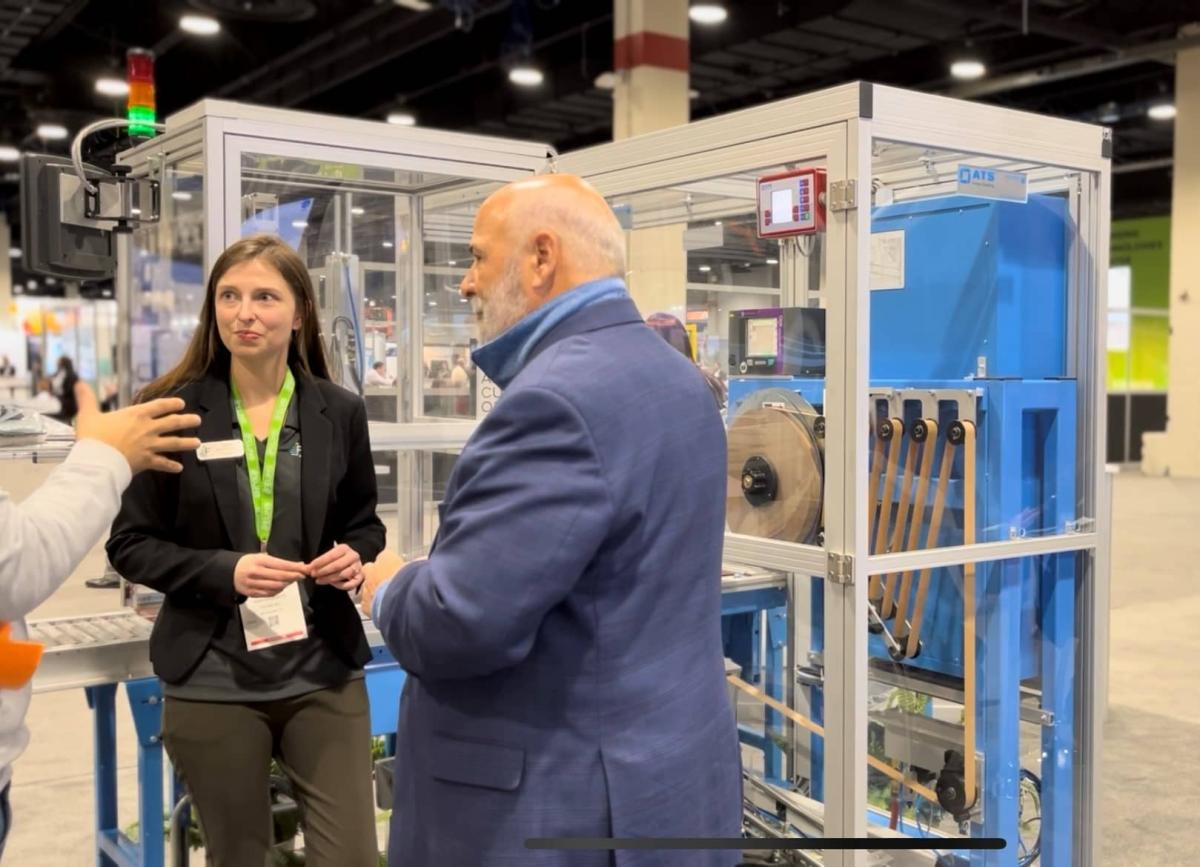 Gina Barrieau and Andrew Barrieau of Felins, Inc. discuss ideas with a customer at their ProMat 2023 booth