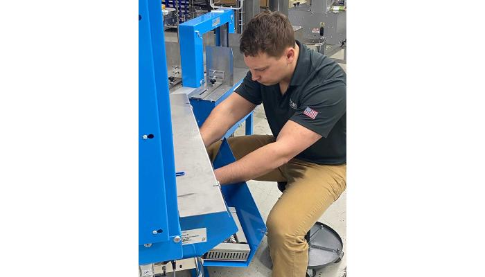 Anthony repairs a US-2000 Bander machine
