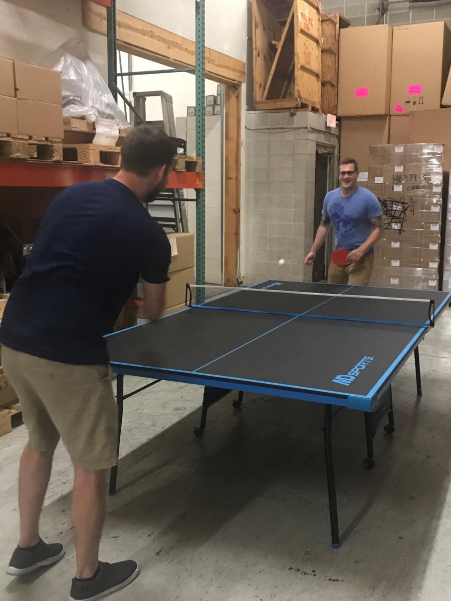 employees playing ping pong