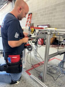 Collin Niederman, Service Manager at Felins, works on a machine. 