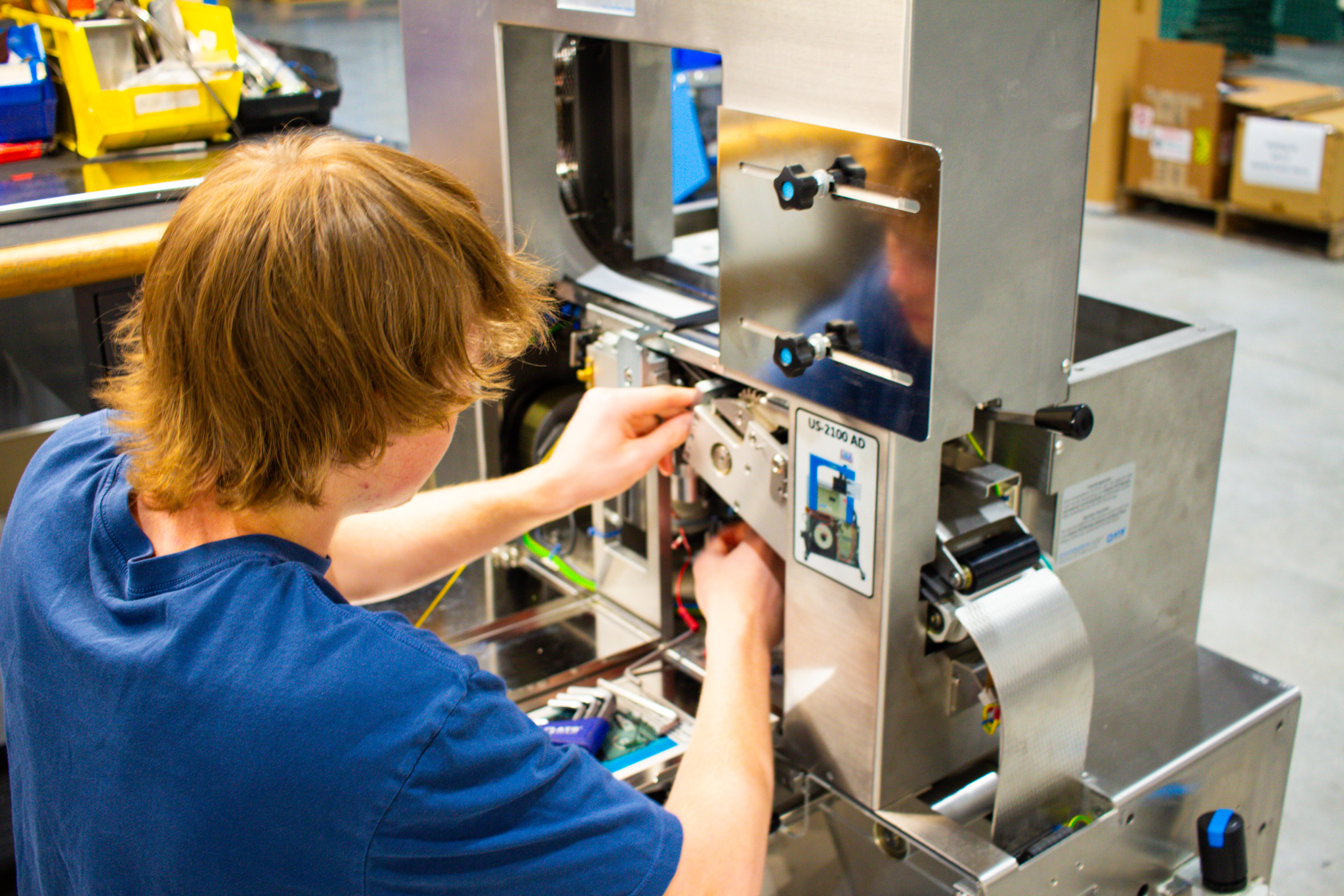 2024 – Service Department-13 Keegan McKillip working on food-sleever machine